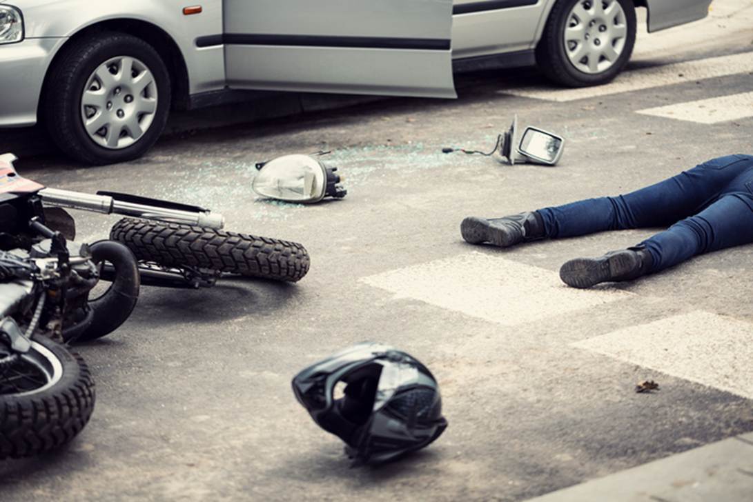 A person lying on the ground next to a motorcycle

AI-generated content may be incorrect.